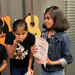 The excitement of receiving a certificate of achievement. We celebrate every student's progress, and these moments of pride are what make our kids' programs so special.