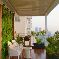 From this angle, you can see how the different elements of the terrace work together. The rich wooden flooring leads the eye from the cozy seating nook past the bar area towards the open view, creating a seamless flow.