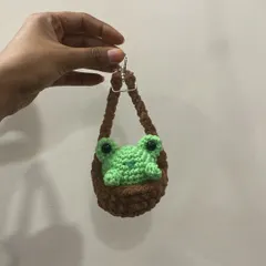 This little green frog peeking out of a brown pouch is one of my most loved keychain designs. It's so full of personality and is sure to make you smile.