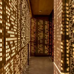 Light is not a utility but a material to be sculpted. Here, in the House of Solid Stone, hand-cut stone screens, or jaalis, transform sunlight into a dynamic pattern, bringing life and movement to the interior spaces while ensuring privacy and thermal comfort.