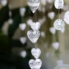 Handmade with heart, celebrated with soul. These hanging decorations, crafted from paper punched into hearts and circles from musical sheets, added a delicate and meaningful touch to the decor.