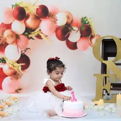 A candid moment of excitement from our red, pink, and gold themed shoot. I focus on capturing natural expressions as your baby explores the birthday setup.