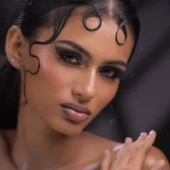 We teach you to push creative boundaries. This high-fashion editorial look combines a dramatic smokey eye with intricate, sculpted hair details, demonstrating the kind of avant-garde artistry required for runway shows and magazine shoots.