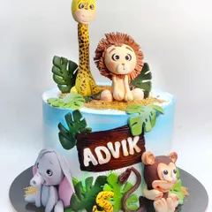 This jungle animal cake is overloaded with cuteness, featuring a hand-molded lion, giraffe, elephant, and monkey. All the figures on this chocolate truffle cake are edible and safe for kids.
