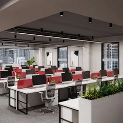 Another perspective of the Pune office, highlighting the flow between workstations and the use of modern track lighting against a dark ceiling. This industrial design element adds character while ensuring the space is well-lit and functional.
