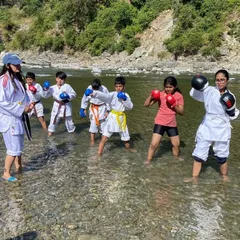 Teaching a kids' karate class right in the middle of a river. Training in water adds a new level of resistance and challenge, helping them build strength and balance in a fun way.