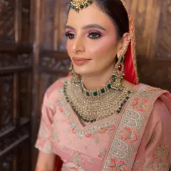 A portrait of my Anand Karaj Bride. The soft pink and green tones in her outfit and jewelry are complemented by a radiant, glowing makeup look.