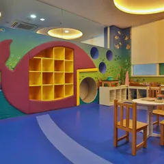 A whale-shaped bookshelf and play tunnel create a fun and functional centerpiece in this underwater-themed room. We design every element to be both a storage solution and a tool for imaginative play.