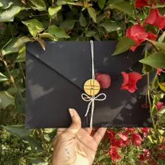 The presentation of a personal note is just as important as the words inside. This custom handwritten letter is enclosed in a simple black envelope, tied with twine and secured with a wooden button, creating a rustic and heartfelt first impression.