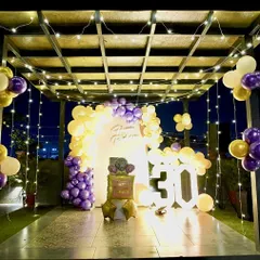 A wider view of the 30th birthday setup, showcasing how the decor fills the pergola space. The fairy lights and balloon arrangements create an immersive and festive party zone.