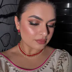 A close-up of my hair and makeup for an evening out. I created a glowing, bronzed look with a soft brown smokey eye and a sleek, pulled-back hairstyle.