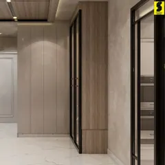 A corridor in our Delhi project featuring clean lines and a neutral palette. The design uses a mix of high-gloss and wood-textured panels to create a sophisticated and seamless transition between spaces.