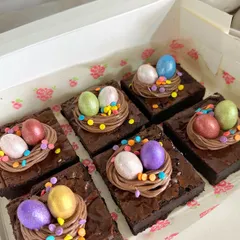 My egg nest brownies are a bestseller every Easter. I top rich, fudgy brownies with a swirl of chocolate buttercream, colorful sprinkles, and shimmering mini chocolate eggs.