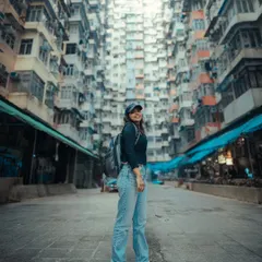 A full-length shot of me at the same location in Hong Kong. I love immersing myself in the places I visit, and this photo captures the feeling of being dwarfed by the city's incredible architecture.