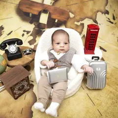 Not all babies sleep through their session, and I love capturing their bright, curious expressions. This "Boss Baby" travel theme features an awake newborn with fun props like a miniature laptop, suitcase, and a vintage telephone.