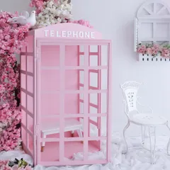 A fairytale waiting to happen. This is our popular pink telephone booth prop, surrounded by beautiful cherry blossoms. It’s a versatile setup that’s perfect for creating magical and whimsical portraits for your little one.