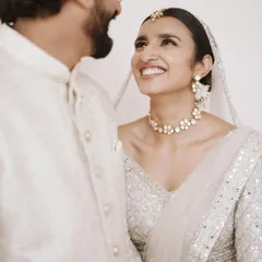 A radiant smile from the bride, Lorraine, as she looks at her groom, Vassim. Their all-white attire for their ceremony is a picture of elegance and grace.