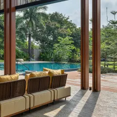 The view from the veranda of the K House looks out onto the pool and lush gardens. We used tall pillars to frame the landscape, creating a picturesque scene that blends architecture with the natural environment.