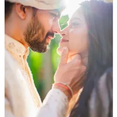 A sun-kissed, romantic close-up of the couple, their faces close together. The natural light and their gentle expressions create a beautiful, dreamy portrait.