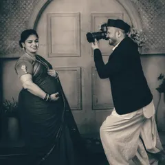 We love to have fun during our sessions. Here, the father-to-be playfully takes on the role of the photographer, adding a touch of lightheartedness to this otherwise formal and artistic vintage shoot.