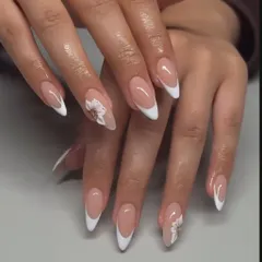 The perfect almond-shaped French manicure, elevated with delicate 3D white flowers on the accent nails.