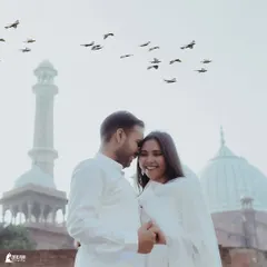 A joyful, candid moment in front of Jama Masjid in Old Delhi. The flight of birds adds a dynamic and magical element to this romantic pre-wedding portrait.