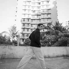 A dynamic, wide-angle shot in an urban setting. This black and white image has a raw, documentary feel, great for a lifestyle or fashion editorial.