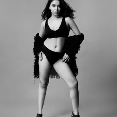 A full-body black and white shot of the same look, showcasing a powerful stance. This is a great example of a classic portfolio image for a lingerie model.
