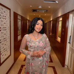 A full-length shot of the "flower girl" bride in her gorgeous floral saree. The soft glam makeup enhances her natural beauty and completes the romantic look.