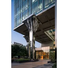 A closer look at the custom-designed faceted stainless steel columns, which reflect the surrounding landscape and add a dynamic, sculptural element to the building's exterior.