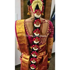 My signature Poola Jada hairstyling. This intricate floral braid is a hallmark of South Indian weddings, created here with fresh jasmine and rose-hued petals for a stunning traditional look from the back.