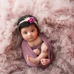 All swaddled up and cozy. I use soft, stretchy wraps to keep babies feeling secure and comfortable during their newborn photoshoot.