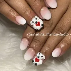 How cute are these? This set features a soft white ombre on short, natural-looking nails, with two accent nails adorned with 3D teddy bears holding red hearts.