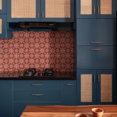 This kitchen is a whisper of South India, with its deep monsoon blues, terracotta-patterned tiles, and natural cane shutters. It’s a space designed with quiet strength, holding fast to what endures rather than chasing trends.