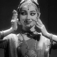 A close-up, black and white shot from a group performance, capturing a moment of shared expression and connection between the artists.