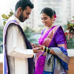 A tender moment during a Maharashtrian engagement as the ring is placed on her finger. We focus on the connection between the couple, capturing their gentle interactions and happy smiles.