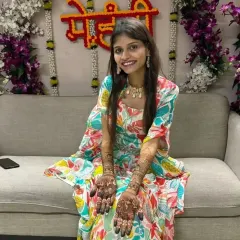 A radiant bride-to-be, all smiles as she shows her full bridal mehandi.