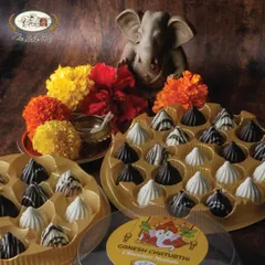 Our chocolate modaks are ready to bring sweetness to your celebrations. This image shows both the 11-piece and 21-piece boxes, perfect for families of any size.