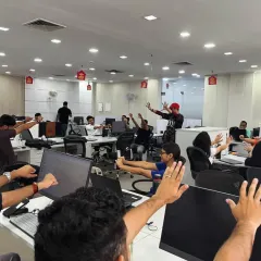 Guiding a corporate team through a series of seated and standing stretches. My focus is on practical movements that can be easily incorporated into the workday to improve posture and reduce physical fatigue.