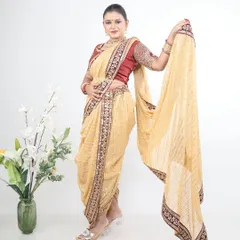 A soft beige or cream-coloured Nauvari with a maroon border, offering a subtle and elegant option for daytime events.