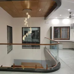 A stunning curved glass railing with a wooden handrail for an interior staircase. This project showcases our ability to work with complex curves and combine materials for an elegant finish.