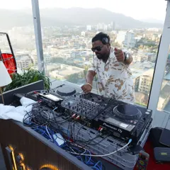 Pointing to the crowd from my DJ booth during a sundowner set. Engaging with the audience is key, even in a more relaxed setting, to make sure everyone is having a good time.