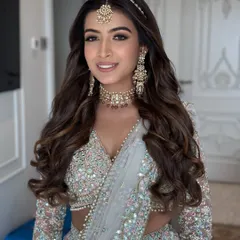 A classic open hairstyle with voluminous waves, perfect for a bride on her wedding day or for a grand reception. I styled this look to be full and flowing, beautifully framing the face and complementing the traditional jewelry.