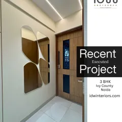 This foyer features a unique, clover-shaped mirror arrangement that serves as a piece of wall art. The design is modern, elegant, and makes the space feel larger.