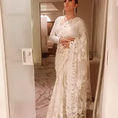 I believe in the timeless elegance of a saree. This intricate white lace saree is perfect for a wedding guest or a sophisticated evening event. I can help you find and style pieces like this that feel both traditional and modern.