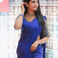 This royal blue saree is paired with a blouse that has heavily embellished sleeves. The gold bead and sequin work creates a stunning contrast and makes the entire outfit perfect for a wedding or reception.