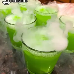 A vibrant green mocktail gets the smoky treatment. The dry ice effect works beautifully with any color, adding a layer of mystery and excitement to the drink presentation.