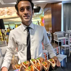 Our staff serving freshly made tacos at a birthday party. Live stations like our taco bar are a fantastic way to provide fresh, customized food that gets guests talking.