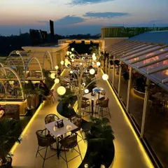 A view of the completed Tipsy Town rooftop in Ayodhya. My goal was to create an organic, flowing space where sculptural lighting and lush greenery guide you through different zones, making the entire rooftop feel like an enchanted garden.