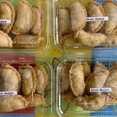 Freshly made Shahi Gujiya, packed and ready to go. These sweet dumplings filled with khoya and dry fruits are a festive favorite that I make with lots of love.